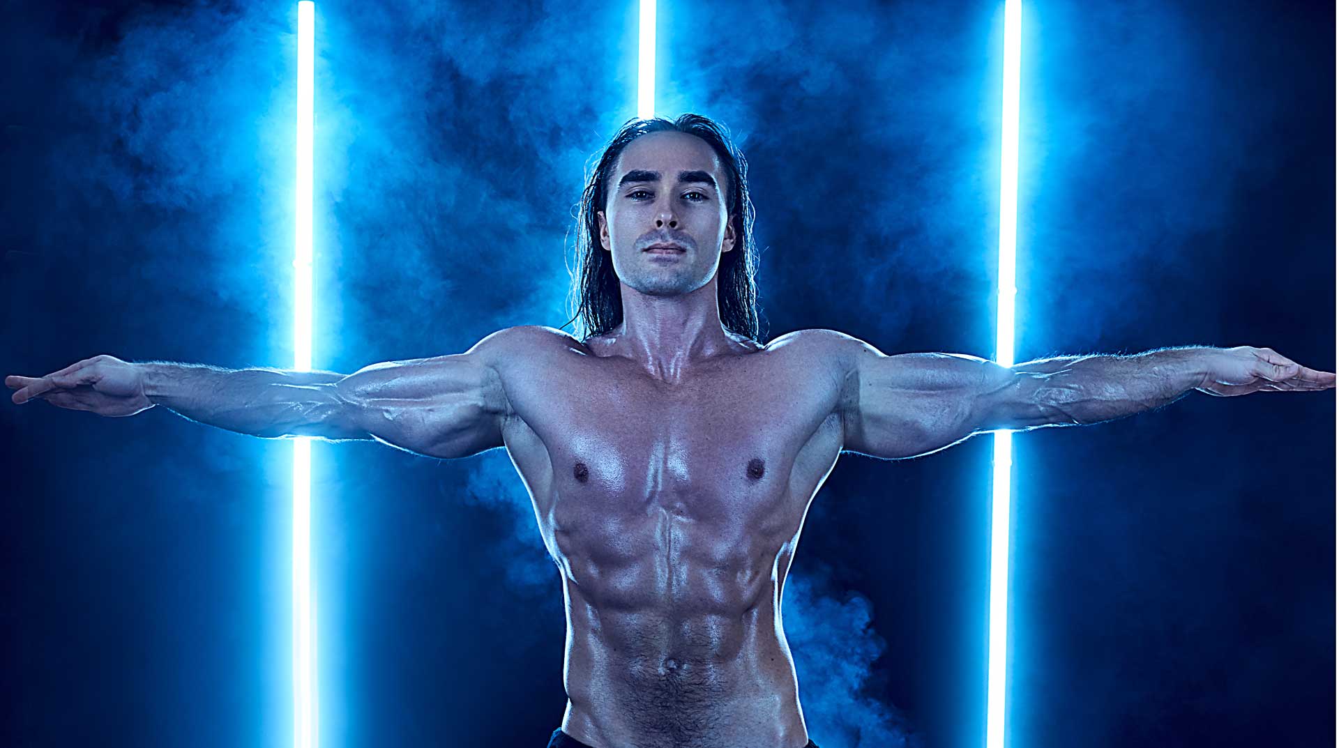 Creative portrait of bodybuilder surrounded by smoke
