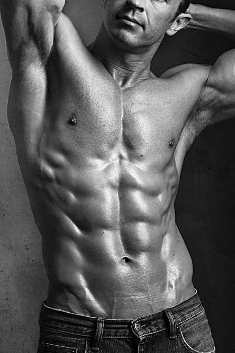 High contrast black and white photo of muscular male fitness model