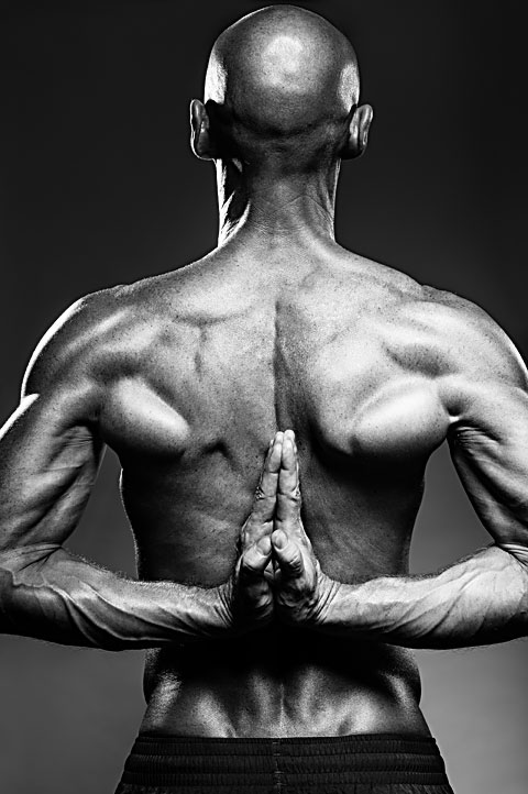 Photo of very muscular Russian gymnast flexing back and arms. Photo by Antonio Carrasco.