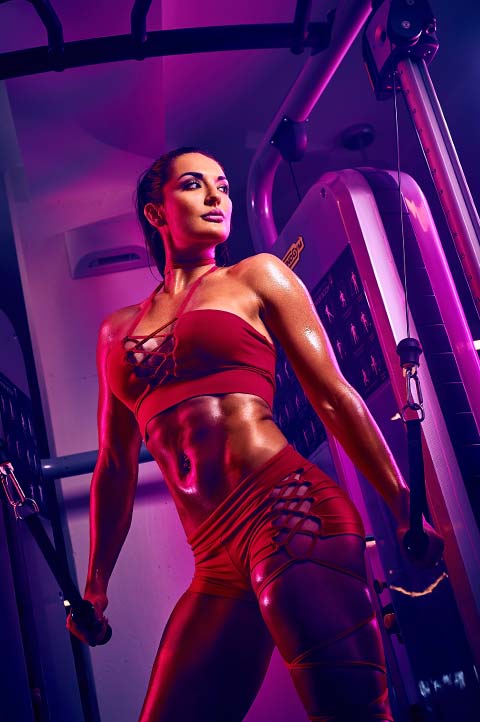 Whitney Johns in red outfit working out at gym. Photo by Antonio Carrasco 2017.